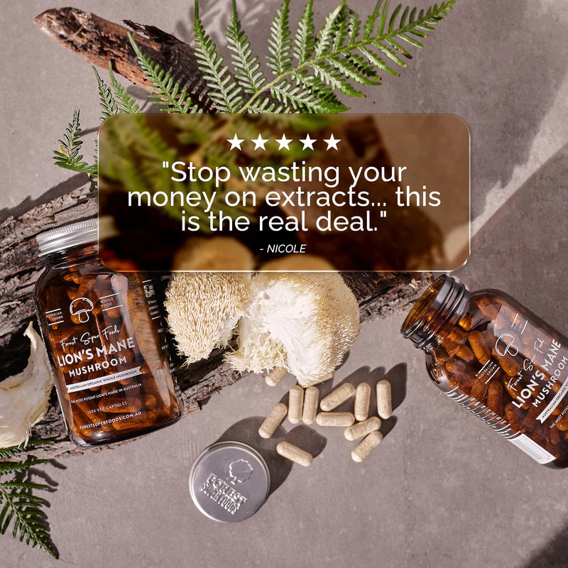 Customer review image with Lions Mane Mushroom Capsules, open jar, capsules, and fresh mushroom beside fern leaves.